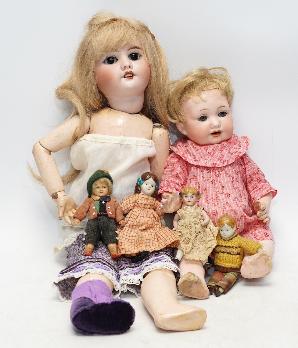 An AM bisque headed doll, an SFBJ 60 bisque doll and four miniature dolls. Condition - poor to fair